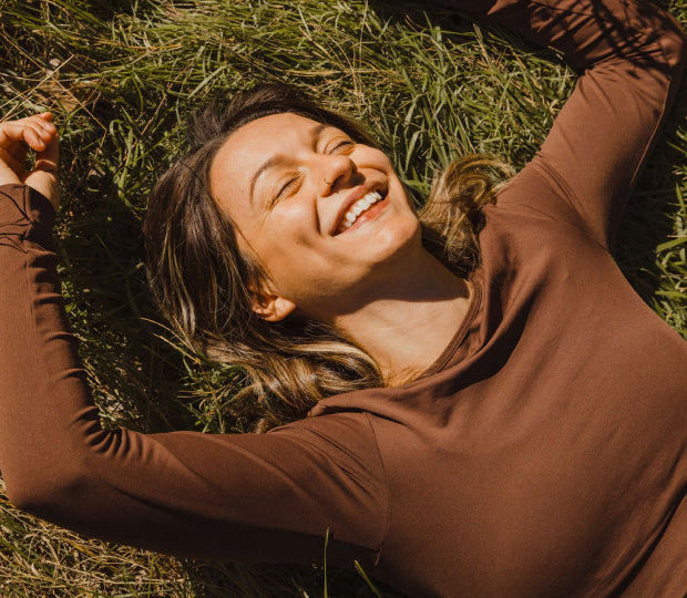 Smiling woman on a patch of grass